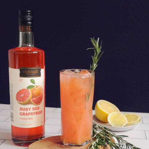 A tall glass of the Ruby Red Elderflower featuring HDC Ruby Red Grapefruit Vodka and a 750ml bottle of HDC Ruby Red Grapefruit Vodka.