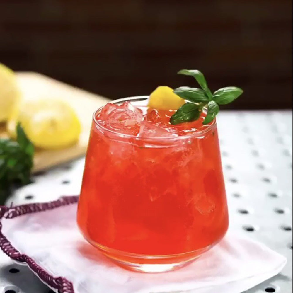 A cocktail using HDC Blood Orange Vodka and Aperol with fresh lemon juice and garnish.