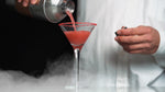 This Cosmo features HDC Blood Orange Vodka served in a martini glass with an orange peel garnish.