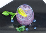 A purple-colored cocktail featuring BSB - Brown Sugar Bourbon and garnished with mint.