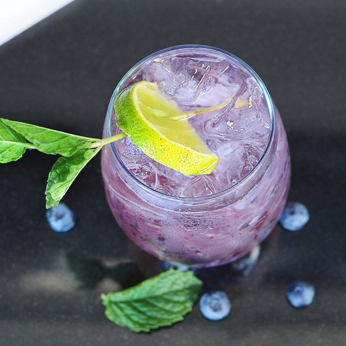 A purple-colored cocktail featuring BSB - Brown Sugar Bourbon and garnished with mint.