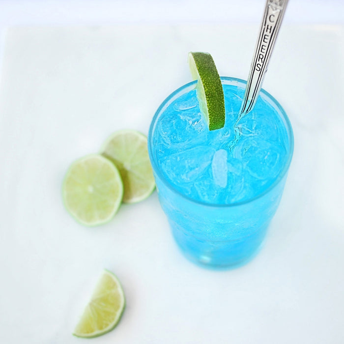 The Batch No. 12 Blue Kamikaze cocktail featuring Batch No. 12 Vodka or Gin and garnished with limes.