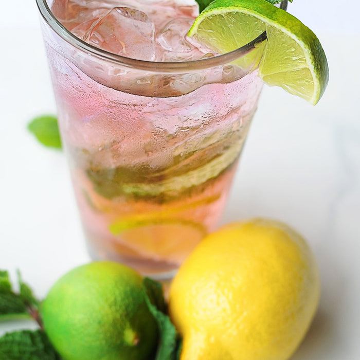 A glass of Blackberry Whiskey Lemonade featuring HDC Elk Rider Bourbon and topped with citrus.