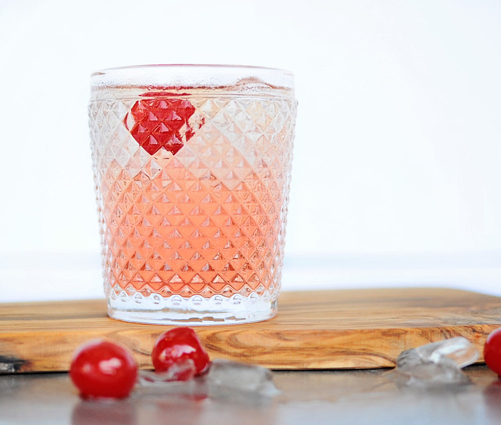 A glass of Dirty Shirley Cocktail featuring HDC Elk Rider Vodka and topped with cherries.