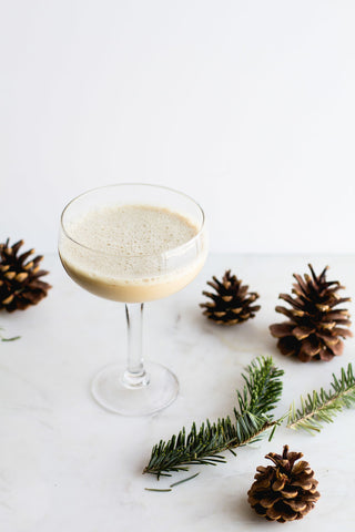 The Eggnog Latte Cocktail (using HDC Elk Rider Vodka) and some decorative pine cones.
