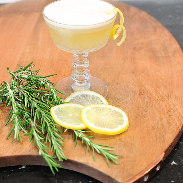 A gin cocktail using HDC Elk Rider Gin poured over ice and garnished with rosemary.