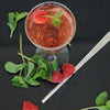 A glass with a mule using HDC Raspberry Vodka and garnished with basil leaves and raspberries.
