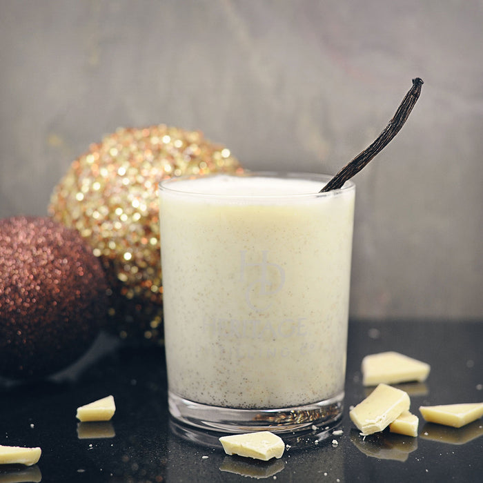 The White Christmas Cocktail in a glass featuring the HDC Vanilla Vodka and some Christmas décor in the background.