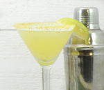 The Key Lime Pie Cocktail featuring HDC Vanilla Vodka in a martini glass with a graham cracker rim.