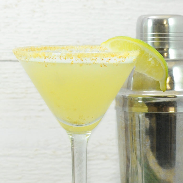The Key Lime Pie Cocktail featuring HDC Vanilla Vodka in a martini glass with a graham cracker rim.