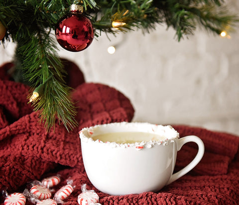 This delicious eggnog cocktail in a crushed candy cane-rimmed mug is made with HDC Vanilla Vodka and can be served hot or cold.