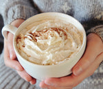 A large mug full of this HDC Vanilla Vodka-based cocktail with whipped cream and chocolate sprinkles on top.