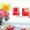 A floral table setting of breakfast options with two BSB Cran Cocktails.