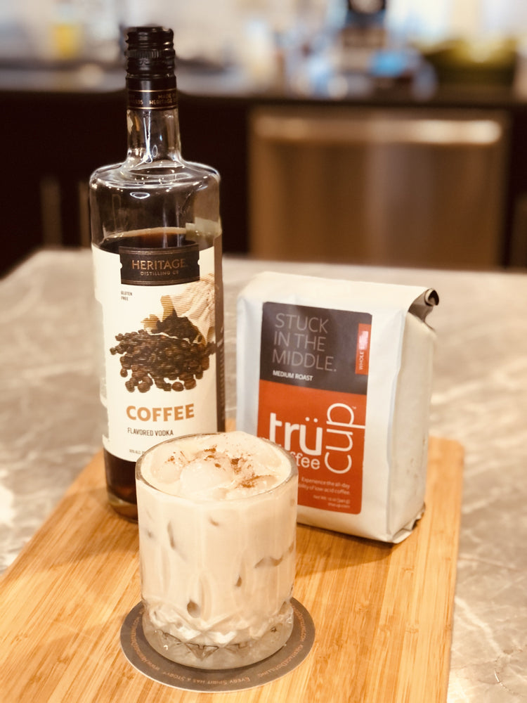 HDC Coffee Vodka and trucup Stuck in the Middle Medium Roast Coffee poured into a glass with ice and garnishes of heavy cream and cinnamon
