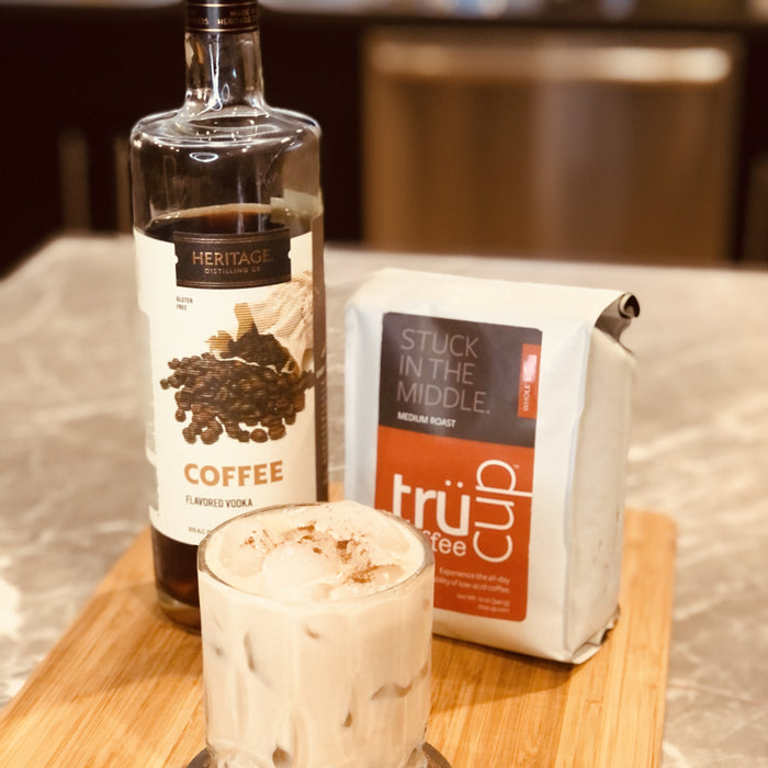 HDC Coffee Vodka and trucup Stuck in the Middle Medium Roast Coffee poured into a glass with ice and garnishes of heavy cream and cinnamon