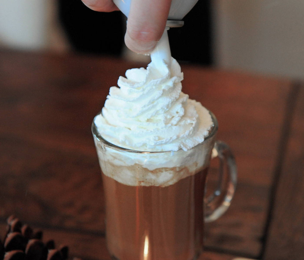 A BSB - Brown Sugar Bourbon-based cocoa cocktail with generous amounts of whipped cream on top.