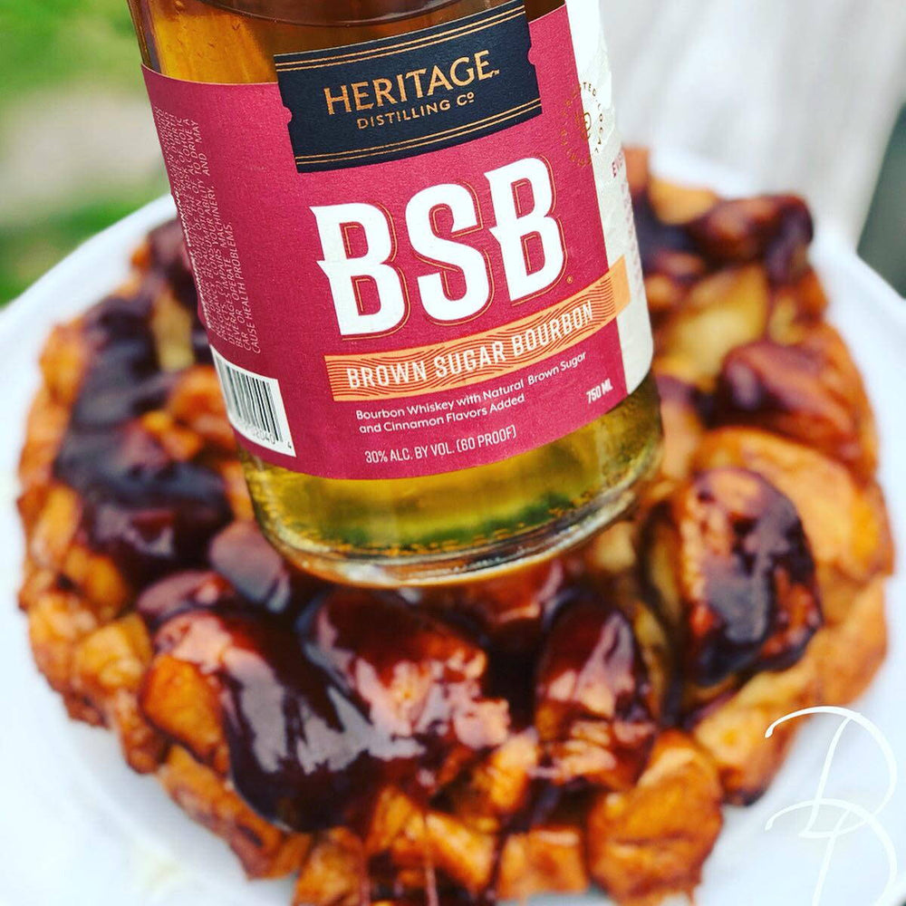 A bottle of BSB - Brown Sugar Bourbon is displayed near the Heritage Homemade Monkey Bread circular loaf.