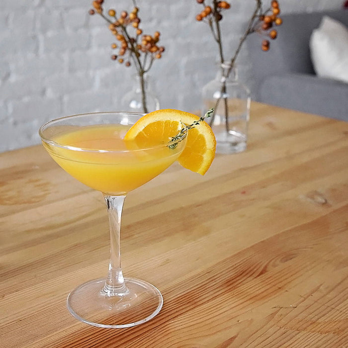 Double strained into a cocktial goblet, this HDC Vanilla Vodka and HDC Citrus Vodka pair is quite refreshing. Its fresh sprig of thyme completes the cocktail.