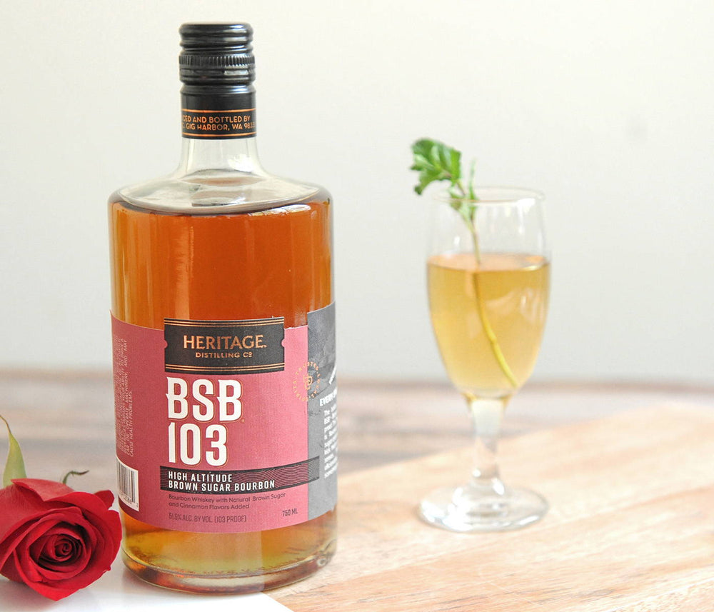 A red rose, a bottle of BSB 103, and the Julep 103 cocktail in a cocktail goblet.