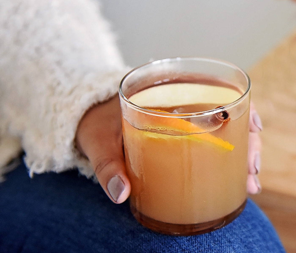 This spiced orange cocktail in a tumbler of ice highlights BSB - Brown Sugar Bourbon and its sweet taste.