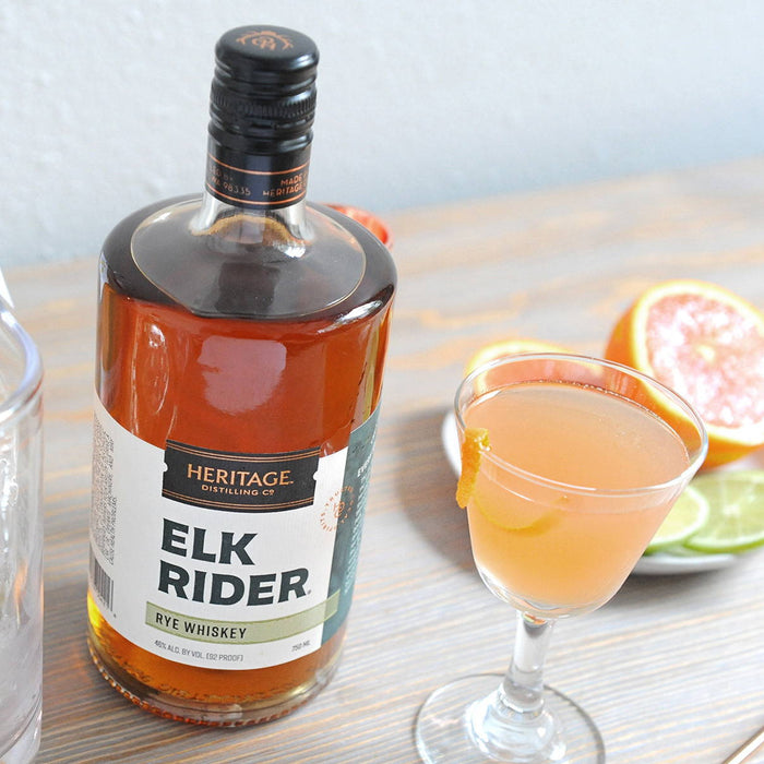 A bottle of HDC Elk Rider Rye Whiskey and a goblet filled with the Algonquin.