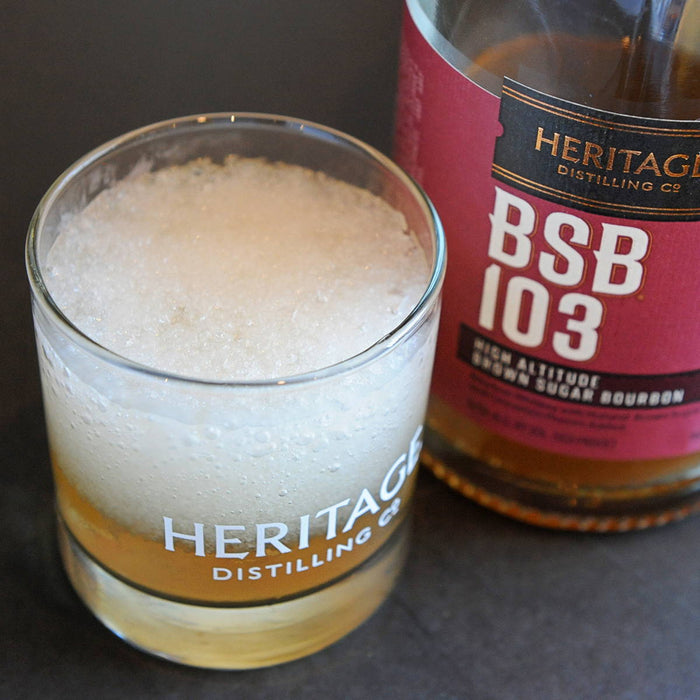 A blended cocktail using BSB 103 in a glass and the bottle used next to it (BSB 103).