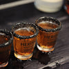 Rim your shot glasses with black sprinkles and pour equal parts HDC Coffee Vodka and HDC Coconut Vodka.