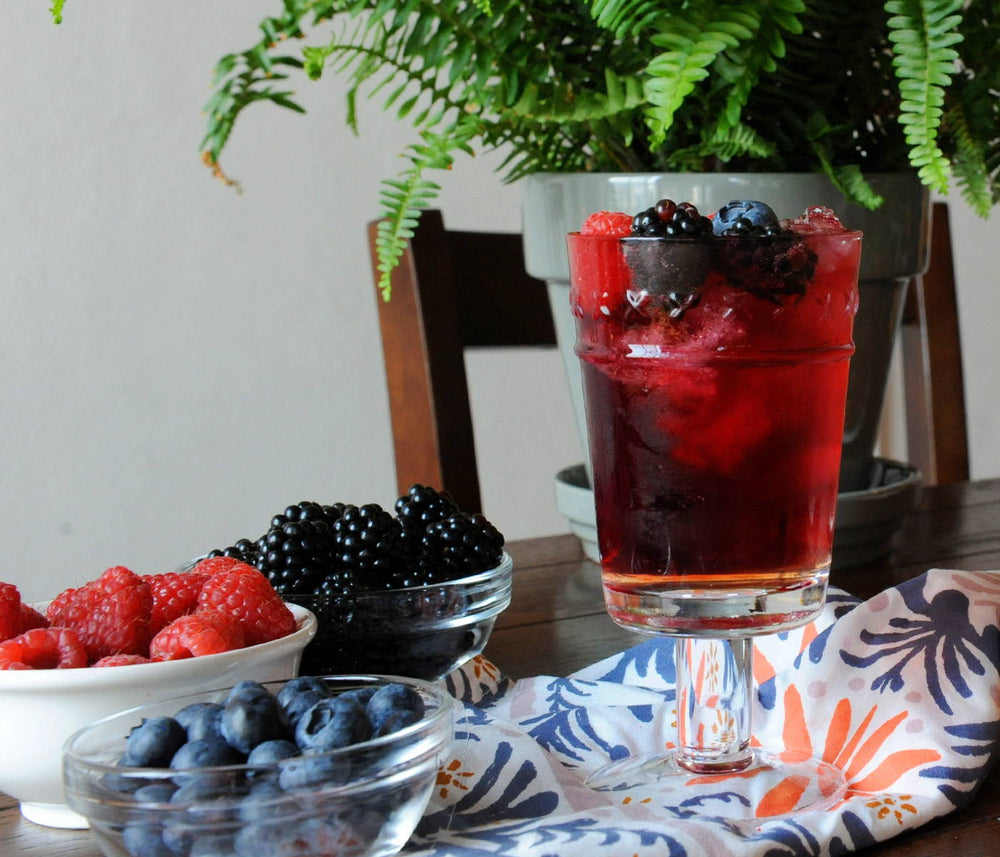 This drink combines BSB Brown Sugar Bourbon, Cabernet Sauvignon, and an orange sparkling water with handfuls of berries to top it off.
