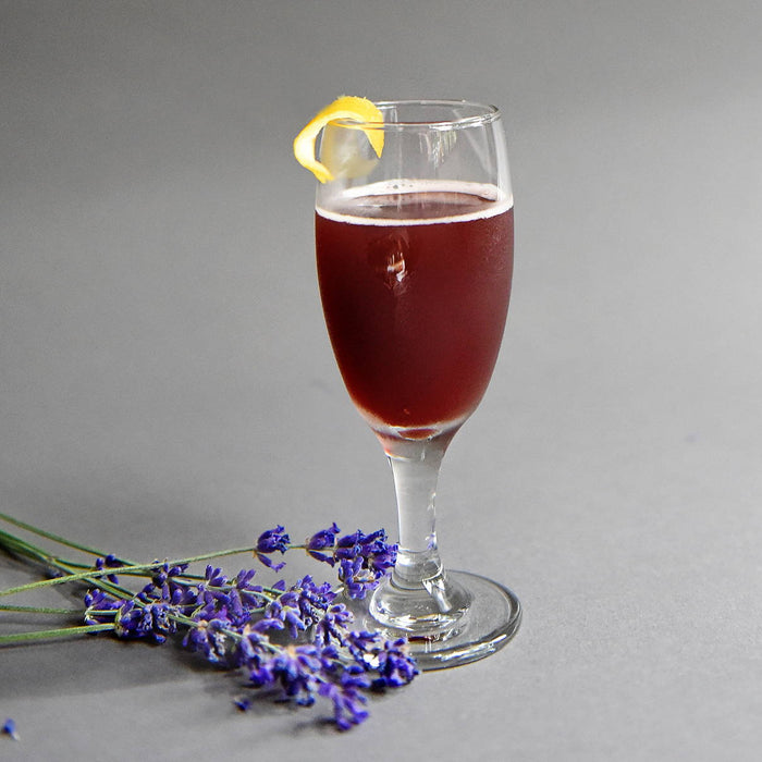 In a daisy goblet, this red cocktail is a blend of HDC Lavender Vodka and Elk Rider Gin to create the perfect cocktail.