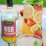 A bottle of BSB - Brown Sugar Bourbon and a pitcher of the BSB Strawberry Smash.