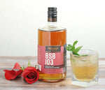A bottle of BSB 103, a red rose, and the Julep 103 cocktail.