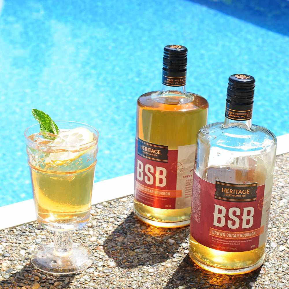 Two bottles of BSB - Brown Sugar Bourbon and a the BSB Tea Cocktail by the pool.