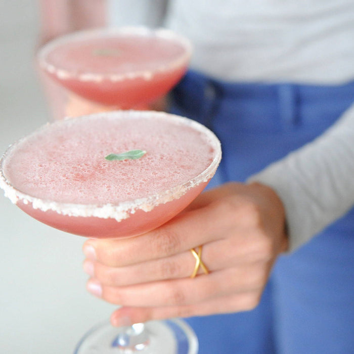 Two full glasses of the Huckleberry Vodkarita. This drink uses HDC Huckleberry Vodka and Dimitri's Margarita Mix to create a light cocktail.