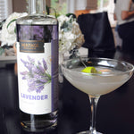 A bottle of HDC Lavender Vodka and a cocktail glass with the Lavender Vodka Creme cocktail.