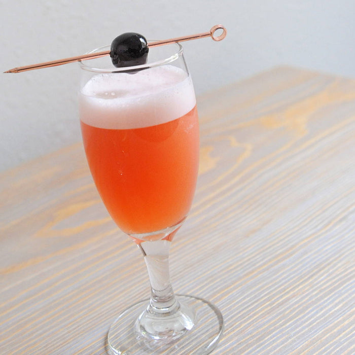 A daisy goblet with the Blood Orange Madness (using HDC Blood Orange Vodka) and garnished with a Luxardo Cherry.