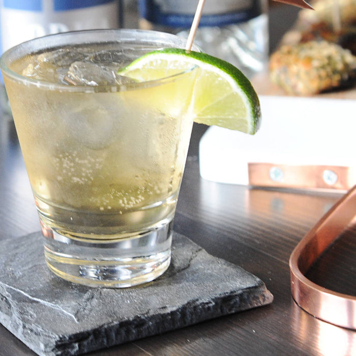 A classic Whiskey Ginger cocktail featuring HDC Batch No. 12 Blended poured over ice and garnished with a lime wedge.