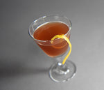 A cocktail made with HDC Coffee Vodka and garnished with a lemon peel twist.