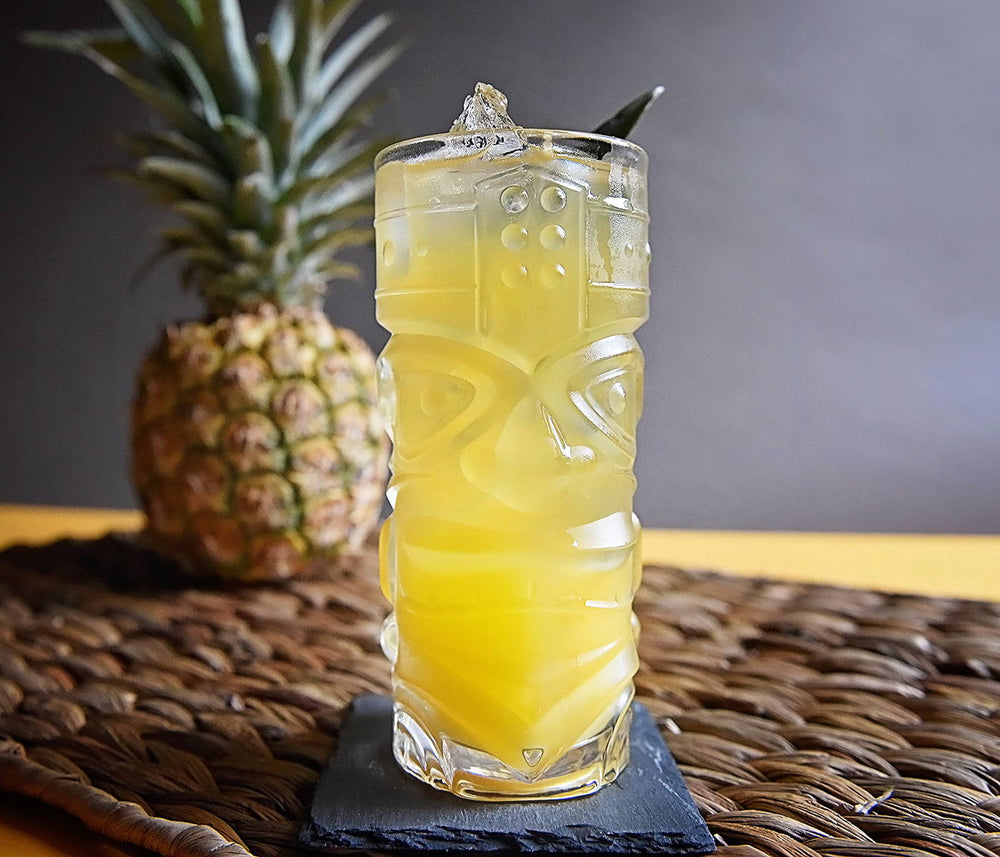 A bright yellow rum-based cocktail with pineapple chunk garnishes. Best made with HDC Commander's Spiced Rum.
