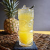 A bright yellow rum-based cocktail with pineapple chunk garnishes. Best made with HDC Commander's Spiced Rum.