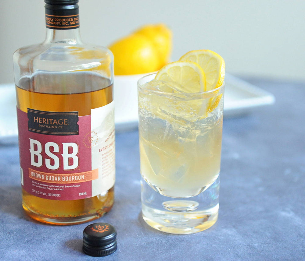 A bottle of BSB - Brown Sugar Bourbon and a tall glass of the BSB Bullpen Cocktail.
