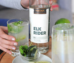 A 750ml bottle of HDC Elk Rider Gin and a gin and tonic cocktail.