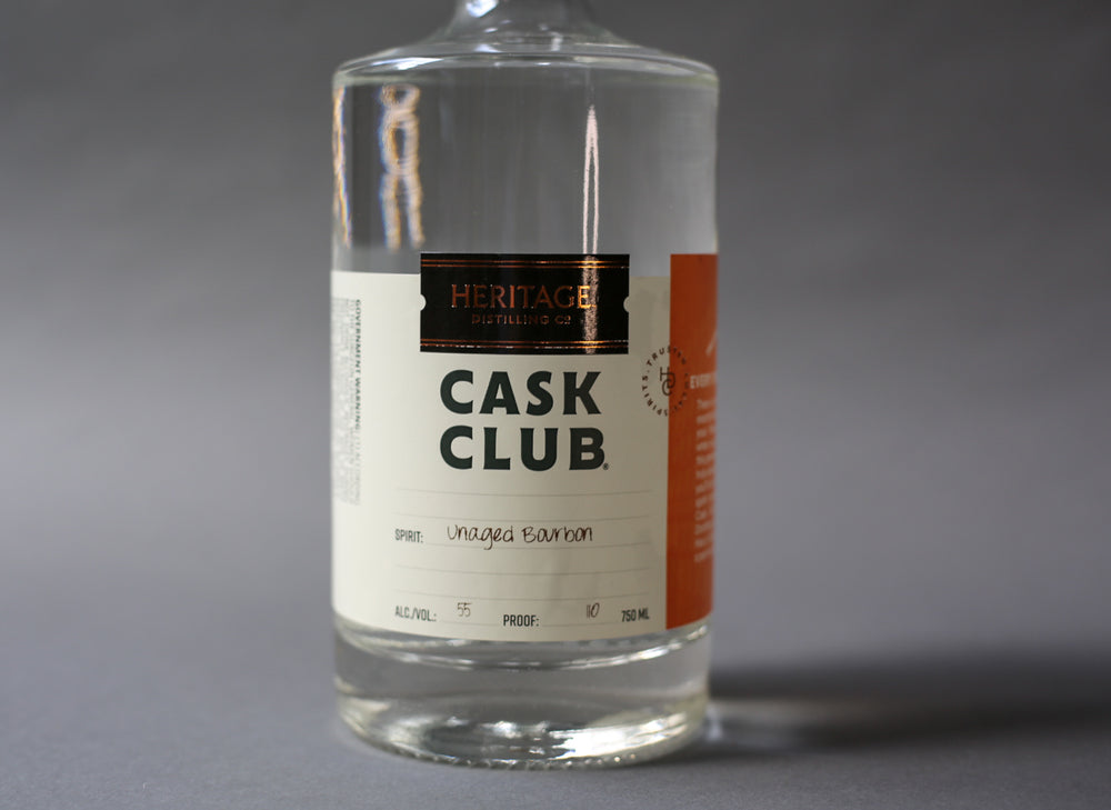 A 750ml bottle of HDC Cask Club Unaged Bourbon (clear liquid).