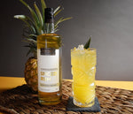 A 750ml bottle of HDC Commander's Spiced Rum and a tall cocktail next to it.